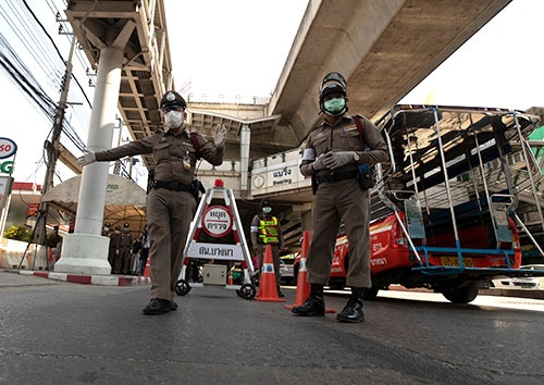 タイでは26日、非常事態宣言が発動された。バンコクでは警察がドライバーの健康状態をチェックしている（写真：AP／アフロ）