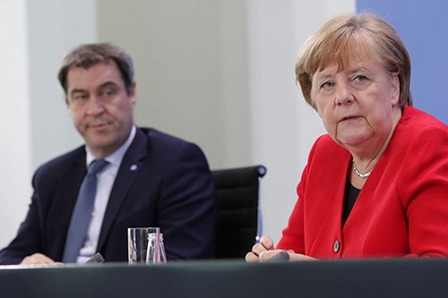 5月6日の記者会見に臨むメルケル独首相(写真右)とバイエルン州首相のマルクス・ゼーダー氏(同左)。ゼーダー氏はドイツの最大与党、キリスト教民主同盟(CDU)の姉妹政党であるキリスト教社会同盟(CSU)の党首でもある (写真:代表撮影/ロイター/アフロ)
