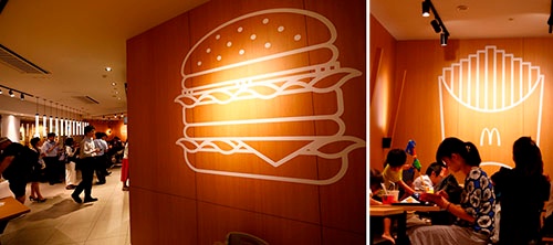 店舗の客席の壁にはハンバーガーやポテトを描いたシンプルな線画がある