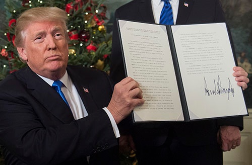 トランプ大統領はエルサレムをイスラエルの首都に認定する書面にサインした（写真：AFP/アフロ）
