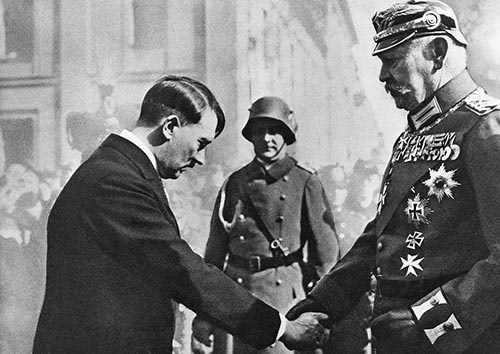 1933年3月、国会の開会記念式典でヒトラー首相(左)と握手するヒンデンブルク大統領(右)。この後、ヒトラー率いるナチスは「史上最悪」の独裁政権となっていく。(写真:Bettmann/Getty Images)